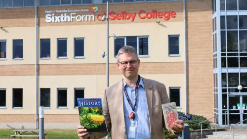 Dr Peter Turner with a copy of History Magazine and the One Day in the Life of Ivan Denisovich book